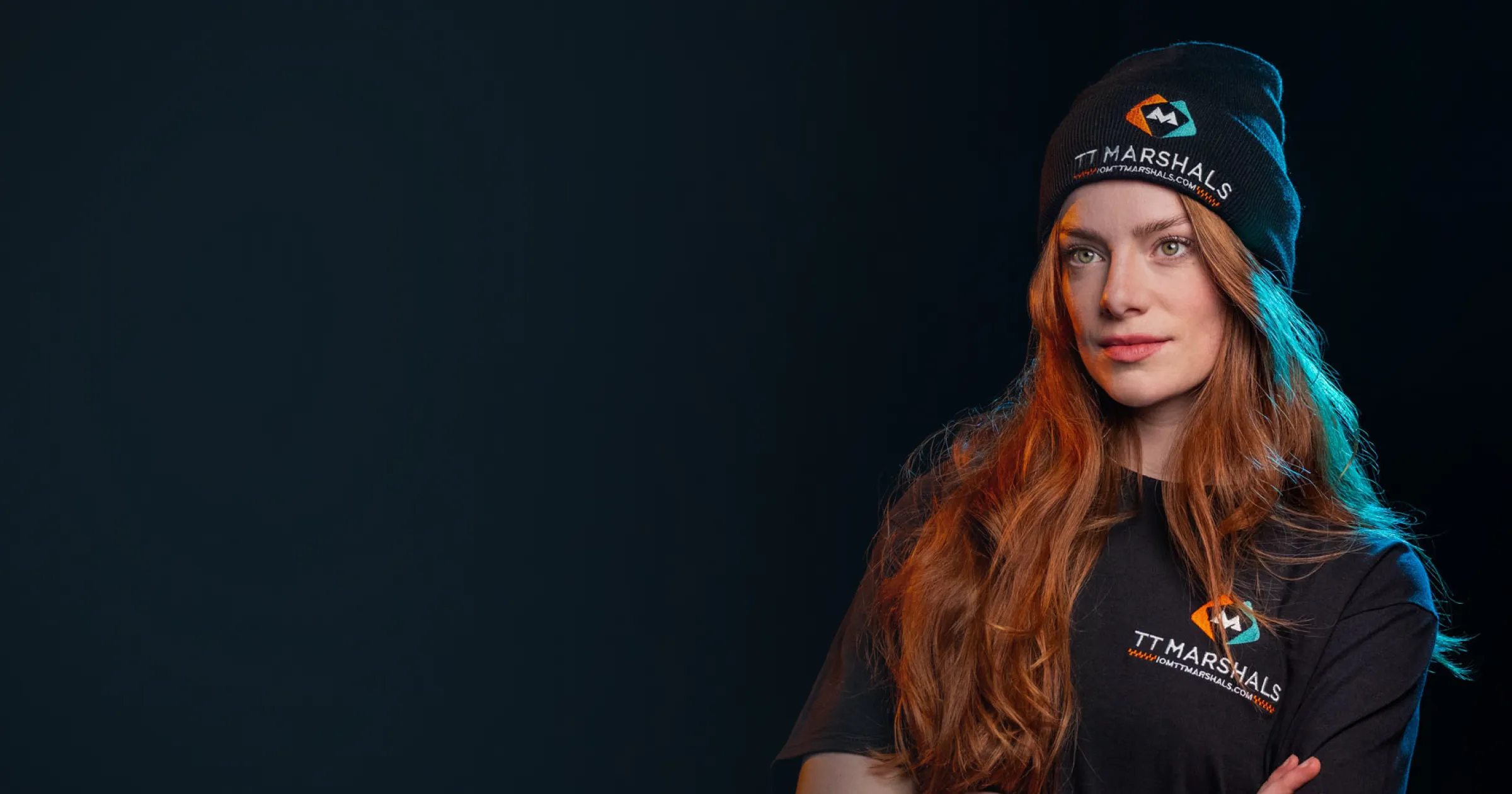 Ella Garvey models in TT Marshals Merchandise, in black beanie and t-shirt.